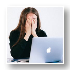 Woman at desk looking stressed